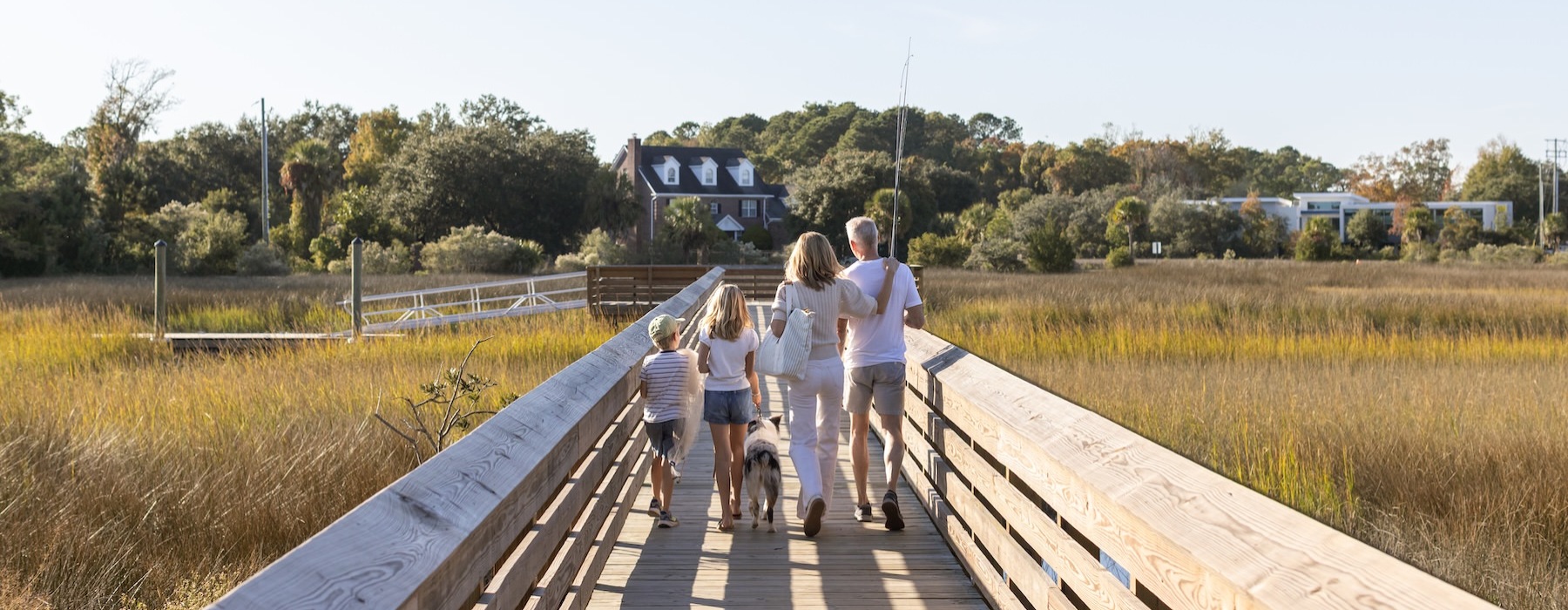 a family walking over a long bridge